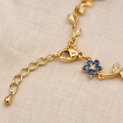 Detail of the lobster clasp, extension chain and small blue flower